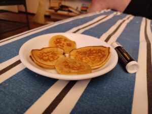 a tiny plate with four teeny pancakes